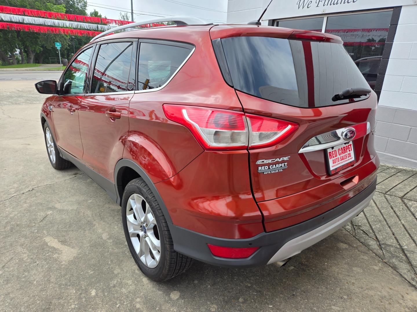 2014 Orange Ford Escape Titanium 4WD (1FMCU9JX7EU) with an 1.6L L4 DOHC 16V engine, 6-Speed Automatic transmission, located at 503 West Court, Seguin, TX, 78155, (830) 379-3373, 29.568621, -97.969803 - Photo#3